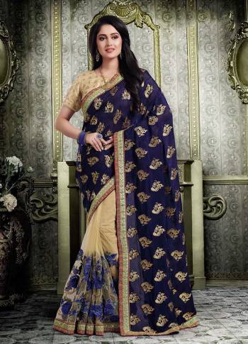 Enhance Your Personality Wearing This Designer Saree In Navy Blue And Beige Color Paired With beige Colored Blouse. This Saree Is Fabricated On Jacquard Silk And Net Paired With Art Silk Fabricated Blouse. 