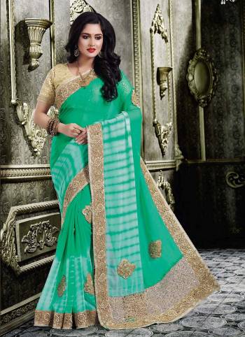 Attract All In This Very Pretty Green Colored Saree Paired With Beige Colored Blouse. This Saree IS Georgette Based With Art Silk Fabricated Blouse Beautified With Heavy Embroidery All Over. 