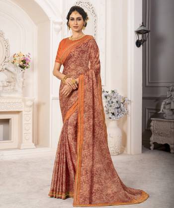 Grab This Pretty Designer Saree In Rust Color Paired With Orange Colored Blouse. This Saree Is Fabricated On Georgette Chiffon Paired With Art Silk  Fabricated Blouse. It Has Prints And Stone work Making The Saree More Attractive. 