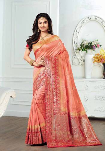 Here Is A Very Pretty Peach Colored Saree Paired With Contrasting Red Colored Blouse. This Saree And Blouse Are Fabricated On Kanjivaram Art Silk Beautified With Weave All Over. 