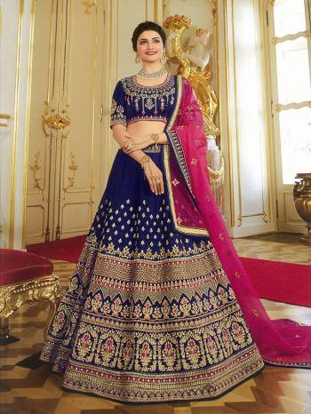 Enhance Your Personality Wearing This Heavy Designer Lehenga Choli In Navy Blue Color Paired With Contrasting Dark Pink Colored Blouse. This Saree And Blouse Are Art Silk Based Paired With Orgenza Fabricated Dupatta. It Has Heavy Embroidery All Over Giving It An Attractive Look.