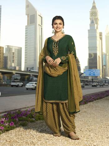 Add This Beautiful Designer Semi-Stitched Suit To Your Wardrobe In Shades Of Green. This Pretty Suit Is In Dark Green Color Paired With Pear Green Colored Bottom And Dupatta. Its Top And Bottom Are Fabricated On Crepe Paired With Chiffon Dupatta.