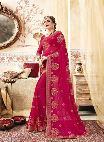 Here Is A Very Pretty Designer Saree In Dark Pink Color Paired With Dark Pink Colored Blouse. This Saree And Blouse Are Georgette Based Beautified With Heavy Jari And Thread Work. 