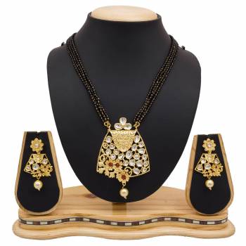 For A Heavy Look, Grab This Heavy designer Mangalsutra Set In Golden Color Beautified With Stone work. This Can Be Paired With Any Colored Heavy Ethnic Attire. Buy Now.