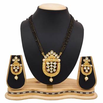 For A Heavy Look, Grab This Heavy designer Mangalsutra Set In Golden Color Beautified With Stone work. This Can Be Paired With Any Colored Heavy Ethnic Attire. Buy Now.