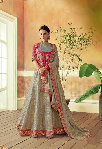 Celebrate royalty and eminence of the Indian culture in this classic grey and pink zari weaved lehenga and treasure your look for a lifetime. 