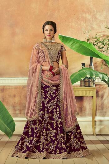 Add a flair of radiance and a dash of romance to your traditonal avatar in this wine and pink hued lehenga embellished with detailed floral embroidery. 