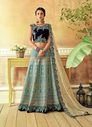 Weave a story of opulence and beauty in this summery hued jacquard lehenga with elaborate details and look captivating. 