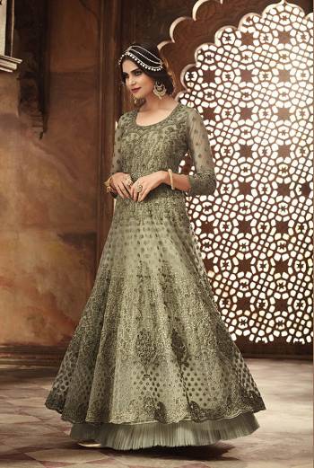 This Season Is About Subtle Shades And Pastel Play, So Grab This Heavy Deisgner Floo Length Suit In Pastel Green Color. Its Heavy Embroidered Top Is Net Based Paired With Santoon Bottom And Net Dupatta. Its Top Is Beautified With Heavy Resham Embroidery And Moti Work. 