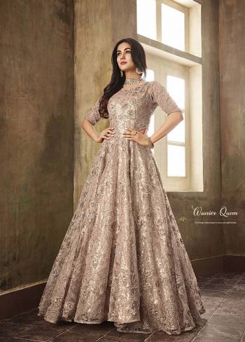 Catch All The Lime Light Wearing This Heavy Designer Floor Length Suit In Light Dusty Pink Color. This Beautiful And Heavy Suit Is Net Based Paired With Santoon bottom. This Pretty Suit Has All The Jazz With The Heavy Sequence Embroidery Which Will Earn You Lots Of Compliments From Onlookers. 