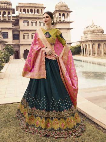 Go Colorful With This Heavy Designer Lehenga Choli In Pear Green Colored Blouse Paired With Teal Blue Colored Lehenga And Pink Colored Dupatta. Its Blouse Is Fabricated On Tafeta Art Silk Paired With Art Silk Fabricated Lehenga And Two Dupattas , One Is Net Based And Other In Silk Base. Buy This Designer Piece Now. 