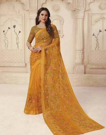 Grab This Pretty Saree In Musturd Yellow Color Paired With Musturd Yellow Colored Blouse. This Saree IS Brasso Based Paired With Silk based Blouse. It Has Pretty Thread Work Over The Saree And Blouse. 