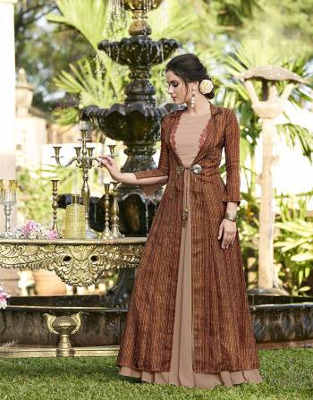 Rich And Elegant Looking Designer Gown Is Here In Beige Color Paired With A Very Pretty Printed Brown Colored Jacket Fabricated On Linen Satin. 