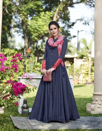 Here Is An Elegant Looking Designer Gown In Blue Color Paired With A Very Pretty Stole In Pink Color Fabricated On Soft Silk. This Gown Is Beautified With Attractive Hand Work And Fancy Buttons. 