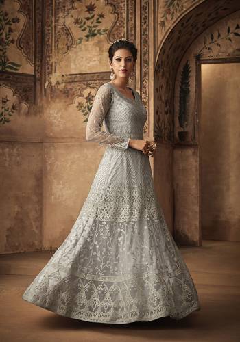 Flaunt Your Rich And Elegant Taste Wearing This Heavy Designer Floor Length Suit In Grey Color Paired With Grey Colored Bottom And Dupatta. Its Heavy Embroidered Top Is Fabricated On Net Paired With Satin Bottom And Net Dupatta. It Rich Delicate Embroidery Will Give An Attractive Look. 