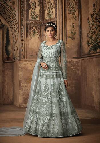 Another Rich Shade Is Here With This Heavy Designer Floor Length Suit In Aqua Blue Color Paired With Aqua Blue Colored Bottom And Dupatta. Its Heavy Embroidered Top Is Net Based Paired With Satin Bottom And Net Dupatta. It Has Pretty Tone To Tone Embroidery Which Gives An Elegant And Rich Look To Your Personality.