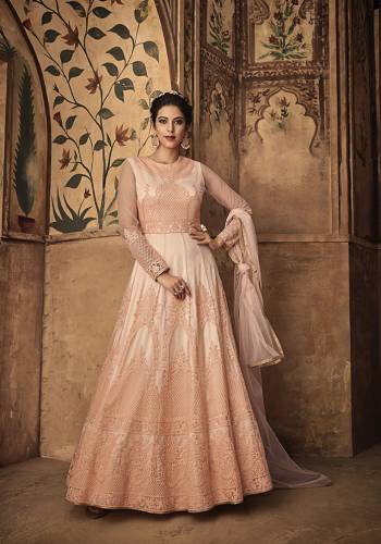 A Must Have Shade In Every Womens Wardrobe Is Here With This Heavy designer Floor Length Suit In Peach Color. Its Top Is Fabricated On Net Beautified With heavy Embroidery Paired With Satin Bottom And Net Fabricated Dupatta. Its Rich Color And Tone To Tone Embroidery Will Earn You Lots Of Compliments From Onlookers. 