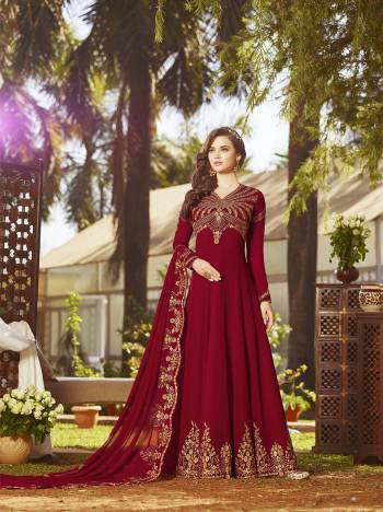 Adorn The Angelic Look Wearing This Heavy Designer Floor Length Suit In Red Color Paired With Red Colored Bottom And Dupatta. Its Heavy Embroidered Top And Dupatta Are Fabricated On Georgette Paired With Santoon Bottom. It Has Pretty Embroidery Over The Yoke And Panel. Buy Now.