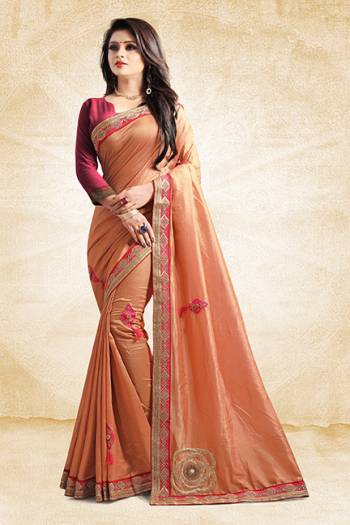 Here Is A Rich And Elegant Looking Designer Saree In Peach Color Paired With Contrasting Dark Pink Colored Blouse. This Saree And Blouse Are Silk Based With A Very Pretty Color Pallete Which Earn You Lots Of Compliments From Onlookers. 