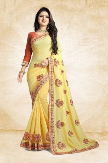 Celebrate This Festive Season With Colorful Attire. Grab This Designer Saree In Yellow Color Paired With Contrasting Orange Colored Blouse. This Saree And Blouse Are Rich Silk Based Beautified Embroidery All Over. Buy Now.