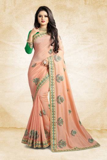 Celebrate This Festive Season With Colorful Attire. Grab This Designer Saree In Light Peach Color Paired With Contrasting Green Colored Blouse. This Saree And Blouse Are Rich Silk Based Beautified Embroidery All Over. Buy Now.