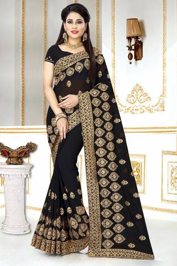 This Wedding And Festive Season, Look The Most Amazing Of All Wearing This Heavy Designer Saree In Black Color. This Saree And Blouse Are Georgette Based Beautified With Heavy Jari Embroidery And Stone Work.