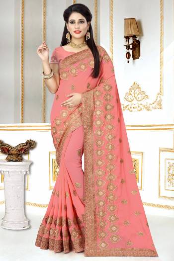 This Wedding And Festive Season, Look The Most Amazing Of All Wearing This Heavy Designer Saree In Peach Color. This Saree And Blouse Are Georgette Based Beautified With Heavy Jari Embroidery And Stone Work.