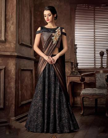 Opt for this copper, glorified lehenga saree imbibed in a unique combination of fabrics and exude mysteriously , majestic aura. 