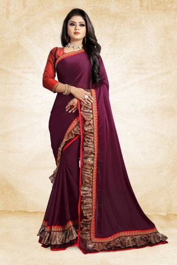 Celebrate This Festive Season With Beauty And Comfort Wearing This Designer Saree In Wine Color Paired With Contrasting Red Colored Blouse. This Saree Is Fabricated On Georgette Paired With Art Silk Fabricated Blouse. It Has Fancy Lace Border Giving It An Attractive Look. 