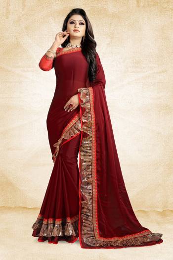 Celebrate This Festive Season With Beauty And Comfort Wearing This Designer Saree In Maroon Color Paired With Contrasting Red Colored Blouse. This Saree Is Fabricated On Georgette Paired With Art Silk Fabricated Blouse. It Has Fancy Lace Border Giving It An Attractive Look. 