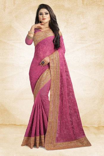 Get Ready For The Upcoming Wedding Season With This Heavy Designer Saree In Magenta Pink Color Paired With Magenta Pink Colored Blouse. This Saree Is Fabricated On Chiffon Beautified With Heavy Embroidery And Heavy Embroidered Lace Border Paired With Art Silk Fabricated Blouse. 