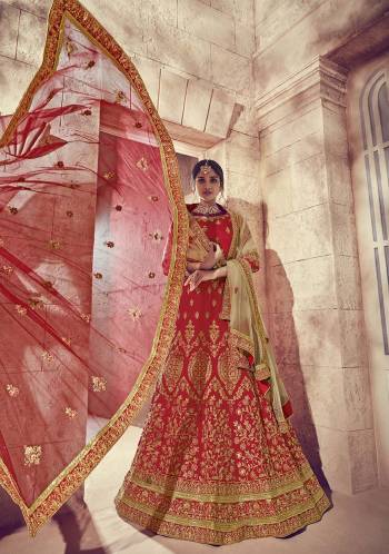 Get Ready For Your Big Day With This Heavy Designer Lehenga Choli In Red Color. This Heavy Embroidered Lehenga Choli Is Fabricated On Art Silk Paired With Net Fabricated Two Dupattas, One In Red And Another In Beige Color. It Is Beautified With Heavy Jari Embroidery and Stone Work. Buy Now