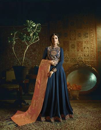 Enhance Your Personality Wearing This Designer Floor Length Suit In Navy Blue Color Paired With Contrasting Dark Peach Colored Dupatta. Its Top Is Fabricated On Satin Georgette Beautified With Heavy Embroidered Yoke Paired With Santoon Bottom And Banarasi Jacquard Silk Dupatta. Buy Now.