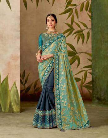 Immerse yourself in the magnificent hues of peacock and walk with a regal essence to your being in this beautiful turquoise weaved saree.