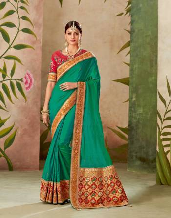 Exhibit tranquility of the turquoise hues in this orange infused turquoise green saree. Opt for a sleek bun to keep the look classy. 