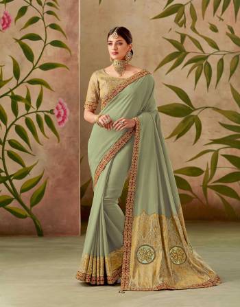 Deluge in the grandeur of the pastel green and red infused silk saree and look majestic. 