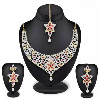 Grab This Heavy Necklace Set For The Upcoming Wedding Season In Golden And Silver Color Beautified With Diamond Work All Over. It Comes With A Pair Of Earrings And A Maang Tika. You Can Pair This Up With Any Colored Heavy Traditional Attire. 