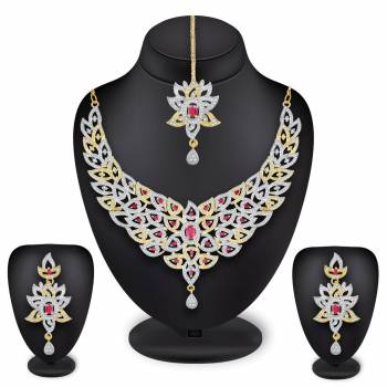 Grab This Heavy Necklace Set For The Upcoming Wedding Season In Golden And Silver Color Beautified With Diamond Work All Over. It Comes With A Pair Of Earrings And A Maang Tika. You Can Pair This Up With Any Colored Heavy Traditional Attire. 