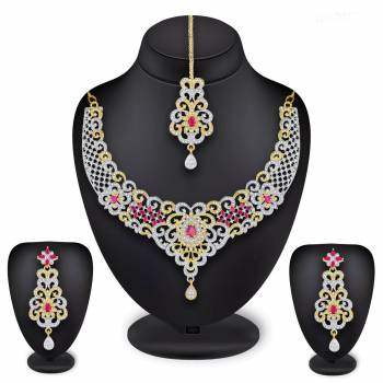 Grab This Heavy Necklace Set For The Upcoming Wedding Season In Golden And Silver Color Beautified With Diamond Work All Over. It Comes With A Pair Of Earrings And A Maang Tika. You Can Pair This Up With Any Colored Heavy Traditional Attire. 