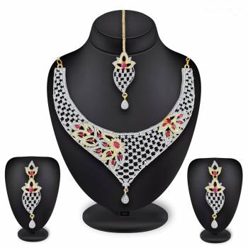 Grab This Heavy Necklace Set For The Upcoming Wedding Season In Golden And Silver Color Beautified With Diamond Work All Over. It Comes With A Pair Of Earrings And A Maang Tika. You Can Pair This Up With Any Colored Heavy Traditional Attire. 