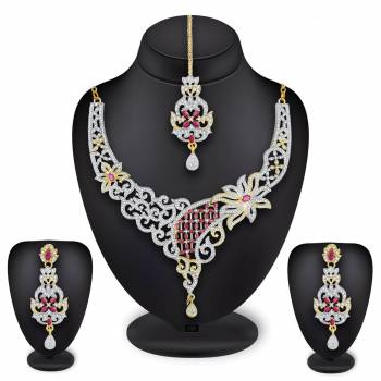 Grab This Heavy Necklace Set For The Upcoming Wedding Season In Golden And Silver Color Beautified With Diamond Work All Over. It Comes With A Pair Of Earrings And A Maang Tika. You Can Pair This Up With Any Colored Heavy Traditional Attire. 