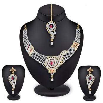 Grab This Heavy Necklace Set For The Upcoming Wedding Season In Golden And Silver Color Beautified With Diamond Work All Over. It Comes With A Pair Of Earrings And A Maang Tika. You Can Pair This Up With Any Colored Heavy Traditional Attire. 