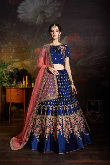 Bright And Visually Appealing Color Is Here With This Heavy Deisgner Lehenga Choli In Royal Blue Color Paired With Contrasting Pink Colored Dupatta. Its Blouse And Lehenga Are Satin Based Paired With Net Fabricated Dupatta. Buy This Lehenga Choli Now.