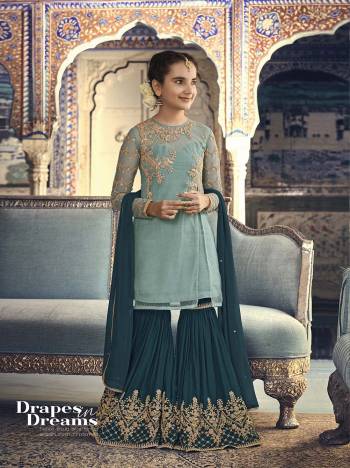 Go With The Shades Of Blue Which Suits Every Age Group, Be It A Mother Or Daughter. Its Top Is In Aqua Blue Color Paired With Teal Blue Colored Bottom And Dupatta. Its Top Is Fabricated On Net Paired With Georgette Bottom And Chiffon Dupatta. It Has Pretty Attractive Embroidery Over The Top And Bottom. 