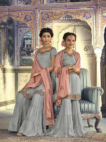 For A Rich And Elegant Look For You And Your Daughter Here Is A Perfect Sharara Suit In Grey Colored Top And Bottom Paired With Contrasting Peach Colored Dupatta. Its Top And Bottom Are Fabricated On Georgette Paired With Chiffon Dupatta. Buy Now.