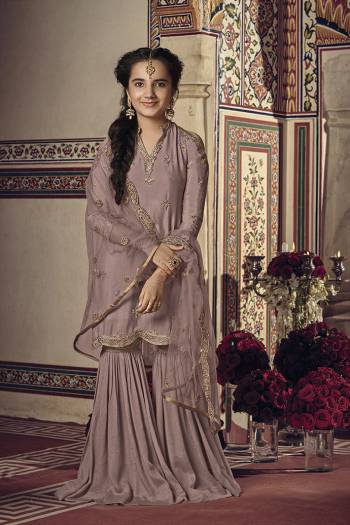 Here Is A Very Beautiful Shade In Purple With This Designer Sharara Suit In Mauve Color For You And Your Daughter. This Pretty Suit Is Georgette Based Paired With Net Fabricated Dupatta. It Is Beautified With Attractive Embroidery Over The Top And Dupatta. Buy Now.