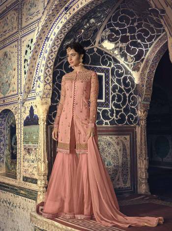 A Must Have Shade In Every Age Group Womens Wardrobe Is Here With This Peach Colored Designer Sharara Suit. This Pretty Suit Is Fabricated On Net Paired With Chiffon Fabricated Dupatta. Grab This Sharara Suit For You And Your Daughter Which Will Definitely Earn You Guys Lots Of Compliments From Onlookers. 