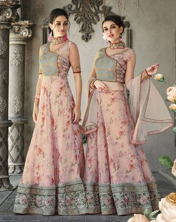 Here Is A Designer Lehenga Choli For The Upcoming Festive And Wedding Season. This Designer Lehenga Choli Can Be Stitched As A Floor Length Suit As Per Your Occasion. Its Blouse Is Fabricated On Art Silk And Net Paired With Oragenza Fabricated Floral Printed Lehenga And Net Fabricated Dupatta. Buy This Now.