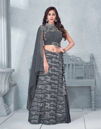 This glittering silver Grey lehenga with an asymetric blouse is as sensual and as charismatic as it gets.  Add statement earrings to it to complete the look.