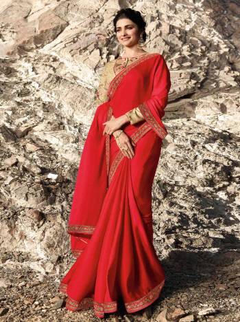 Adorn The Pretty Angelic Look Wearing This Designer Saree In Red Color Paired With Beige Colored Blouse. This Saree Is Fabricated On Soft Silk Paired With Art Silk Fabricated Blouse. It Is Beautified With Attractive Embroidery And Floral Prints. 